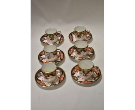 Six Royal Crown Derby coffee cans and saucers, having cobalt Blue and Rust Flower decoration with Scrolls Pattern Number 1270