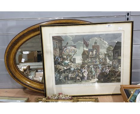 Colour print after William Hogarth, "Southwark Fair" and a bevelled edge oval mirror within a varnished wood frame (2) 