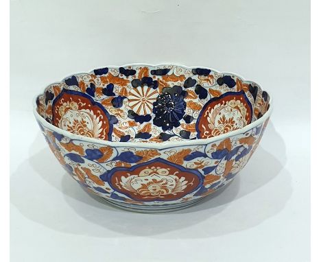 Japanese Imari porcelain punchbowl painted in typical colours, with floral medallions, on a scrolling floral ground, scallope