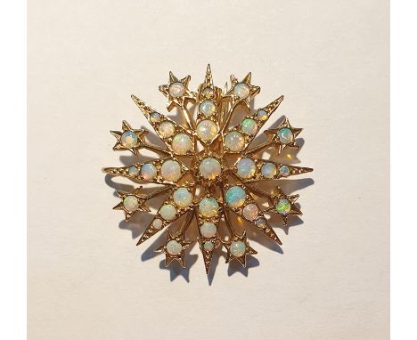 9ct gold and opal star-pattern brooch, eight-pointed and interspersed with smaller stars, set numerous graduated opals, 3cm d