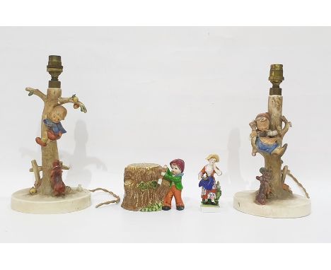 Pair of Goebel pottery lamp bases modelled as children being chased up trees by dogs, each 30.5cm high (with damage), a potte
