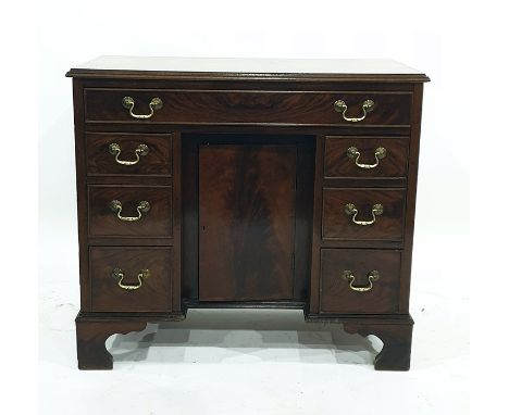 George III style mahogany kneehole desk with single frieze drawer above panelled cupboard flanked by three drawers on either 