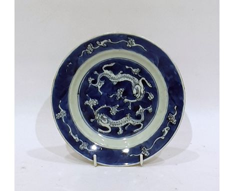 Chinese Kangxi porcelain small dish, circular and decorated with pair of kylin on a blue wash ground, 16cm diameter Condition