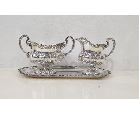Finnish silver coloured metal cream jug, baluster shape, shell enscrolled border, foliate scroll handle, panelled body on sha