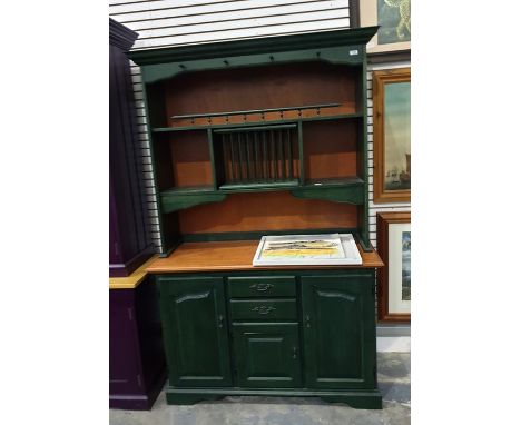 20th century green painted dresser by Candel, the ogee moulded top above assorted compartments, a base of two drawers and thr