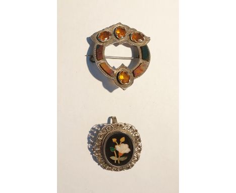 Silver and pietra dura brooch, oval with floral spray decoration, and a Scottish silver, citrine and Scotch pebble brooch of 