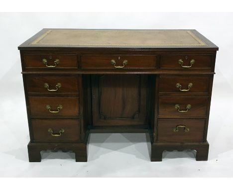 20th century mahogany desk with brown leatherette inset top above the seven assorted drawers, raised on bracket feet, 119.5cm