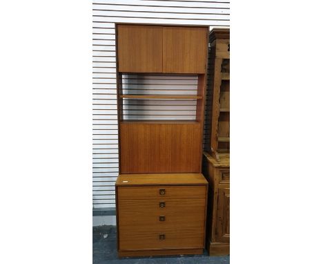 G-Plan lounge unit in teak, with two cupboard doors above two shelves above four enclosing shelf, on a base of four drawers, 
