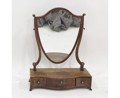 19th century mahogany dressing table mirror, the shield-shaped mirror on a serpentine fronted three-drawer base to ogee brack