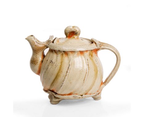 Ruthanne Tudball (American, 1948) Teapot and cover, of twisted form, impressed potter`s seals to bottom rim, 16cm high