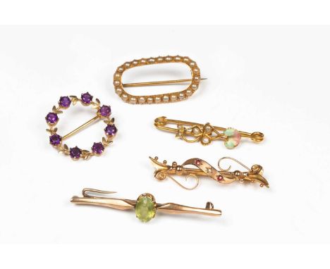 Five Edwardian and later gem set brooches, including a bar brooch set with a central oval peridot in 15ct gold, approximately