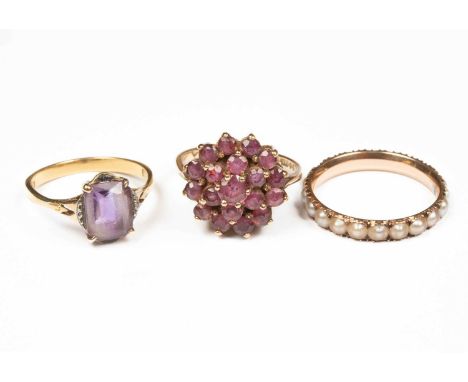 An 18ct yellow gold and amethyst dress ring, size K, gross weight approximately 2.4g, a 9ct yellow gold and ruby cluster ring