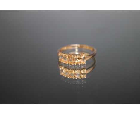 A HALLMARKED 9 CARAT GOLD RING, set with five Citrine style stones, approx weight 1.7g, ring size R 1/2