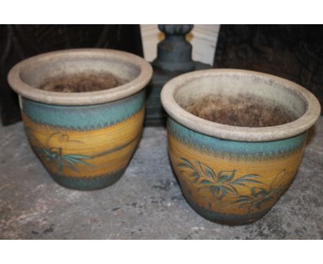 A PAIR OF CERAMIC PLANTERS WITH FLORAL DETAIL