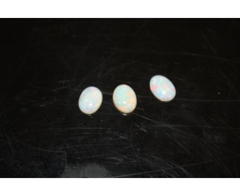 THREE LOOSE OVAL OPAL TYPE STONES