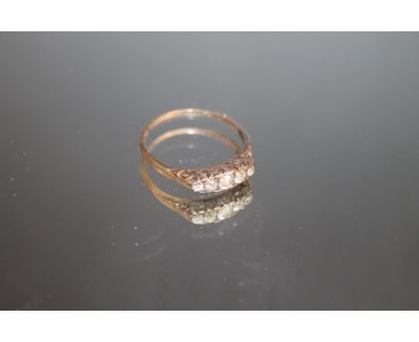 AN 18CT FIVE STONE OLD CUT DIAMOND RING, the central diamond being an estimated quarter carat, approx weight 2.1g, ring size 