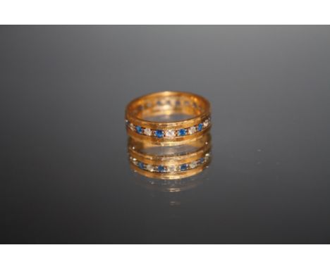 A HALLMARKED 9 CARAT GOLD ETERNITY RING, set with blue and white stones, approx weight 2.7 g, ring size K