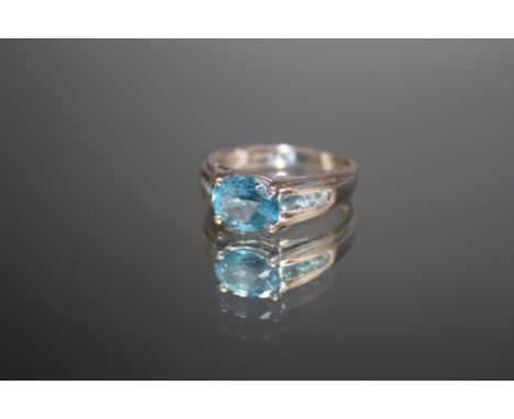 A HALLMARKED 9 CARAT WHITE GOLD RING, set with light blue stones, approx weight 3.1 g, ring size O