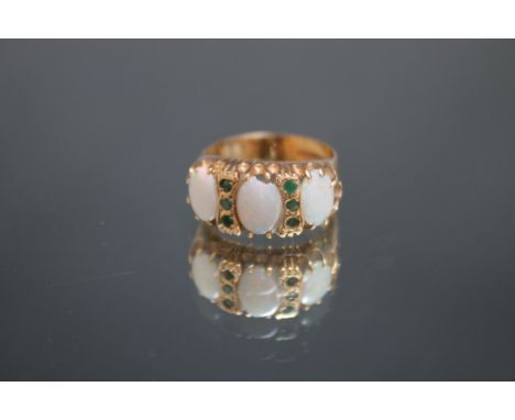 A HALLMARKED 9 CARAT GOLD OPAL AND EMERALD RING, approx weight 4g, ring size M Condition Report:central opal chipped at top