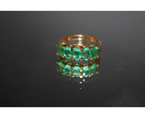 A HALLMARKED 9 CT GOLD RING, set with five emerald style oval stones, approx weight 3.8 g, ring size N