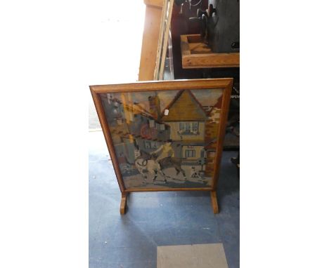 An Edwardian Oak Fire Screen with Tapestry Interior Depicting Horses in a Town 