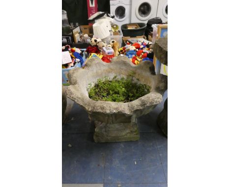 A Concrete Planter with Scalloped on Support
