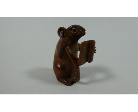 An Interesting Carved Wooden Netsuke in the Form of a Rat Reading