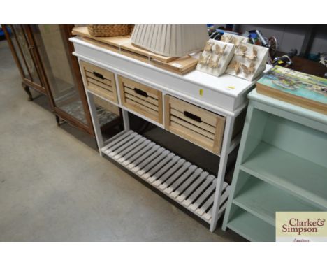 A narrow modern hall unit with three drawers and slated shelf below