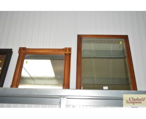 A rectangular bevel edged mirror and another wooden framed mirror