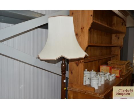 A mahogany standard lamp and shade