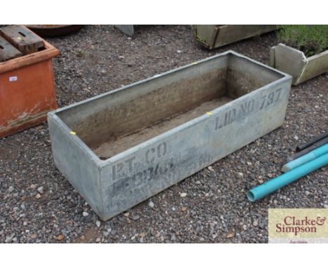 A galvanised water trough drilled out as a planter