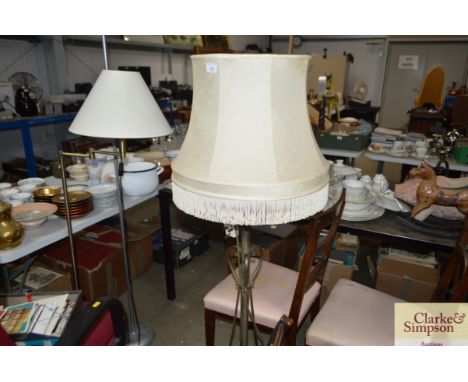 An ornate brass standard lamp and shade