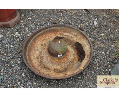 A circular cast iron pig trough AF