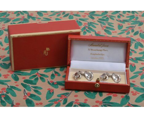 A pair of modern silver cufflinks from Annabel Jones, modelled as a frog united by a chain to a lily pad, with red AJ box and
