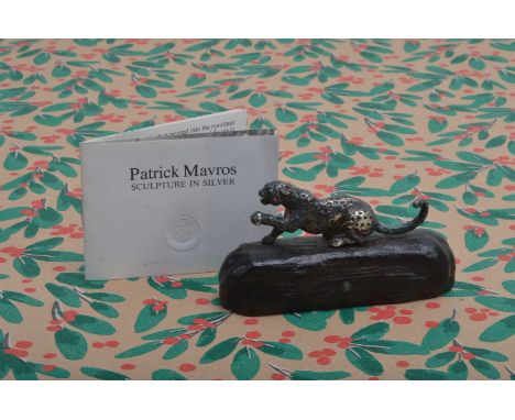 A 1990s silver scuplture by Patrick Mavros, the 9cm wide carved ebony base inset with initial PM and supporting a silver leop