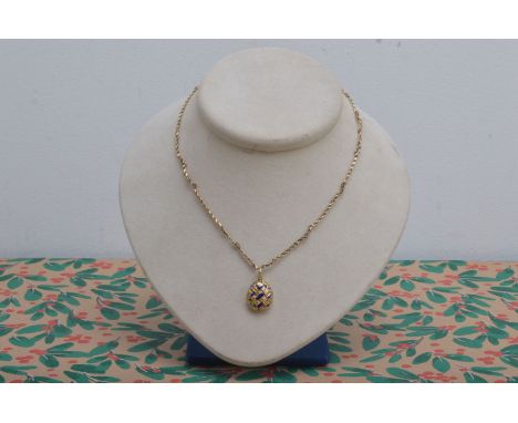 An oval yellow metal and blue enamel drop pendant, circa 1900, the basket front, with flat back containing a lock of hair and