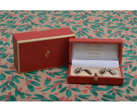 A pair of modern silver cufflinks from Annabel Jones, modelled as a frog united by a chain to a lily pad, with red AJ box and