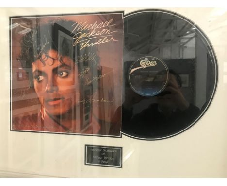 A framed &amp; glazed Michael Jackson thriller LP cover signed by Michael Jackson &amp; his band with COA