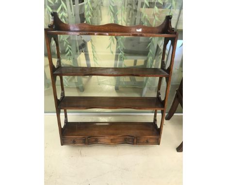 An Edwardian mahogany wall shelf