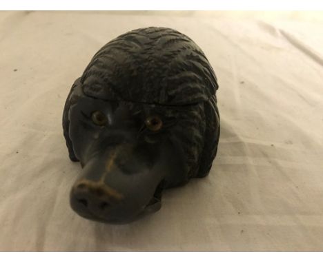 A 19th century Bavarian carved dog's head inkwell, with drilled hole to the mouth as a pen holder