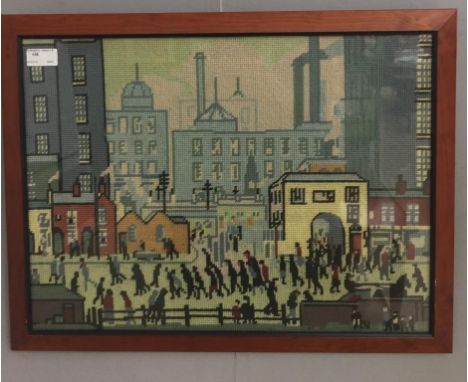 A framed wool tapestry depicting an industrial landscape after Lowry