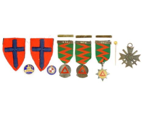 A GERMAN WWII MERIT CROSS WITH SWORDS, TWO SILVER AND ENAMEL ROAD SAFETY AWARDS 1934 AND 1935 AND A GOLD SUBSTITUTE ROAD SAFE