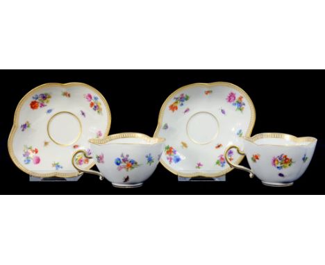 A PAIR OF MEISSEN LOBED CUPS AND SAUCERS PAINTED WITH FLORAL SPRIGS AND INSECTS, 13CM DIAM, CROSSED SWORDS UNDERGLAZE BLUE, 2
