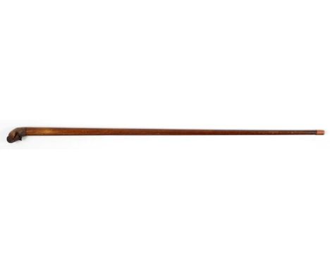 A 20TH CENTURY WALKING STICK, THE GRIP CARVED AS A DOG'S HEAD WITH ARTICULATED JAW AND INSET GLASS EYES, 86CM