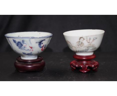 Two various Chinese painted ceramic tea bowls including: blue and white blossom decorated, with wood stand, (rim chip); and p