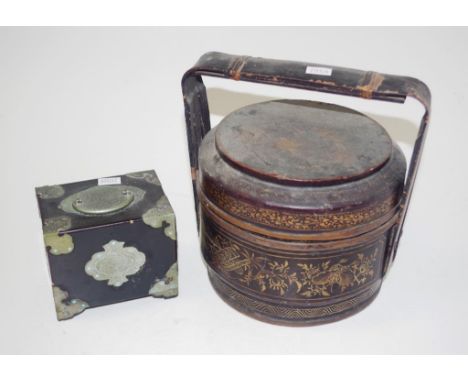 Two various Chinese decorative pieces including: black lacquer food carrier; and brass bound wooden playing card box.
