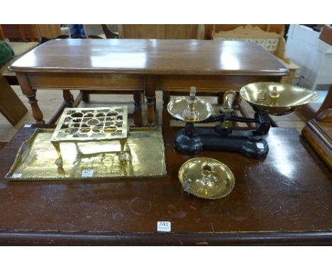 A set of scales with weights, a brass tray, a brass trivet and a chamberstick