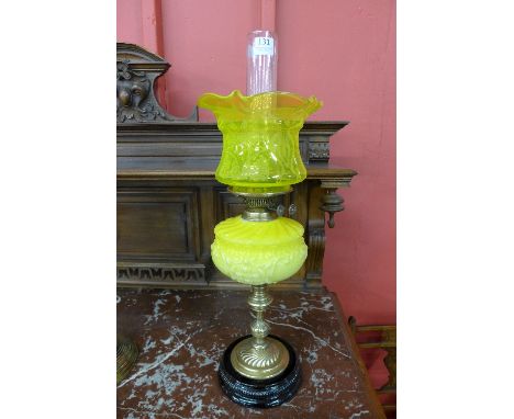 A Victorian brass and yellow glass oil lamp