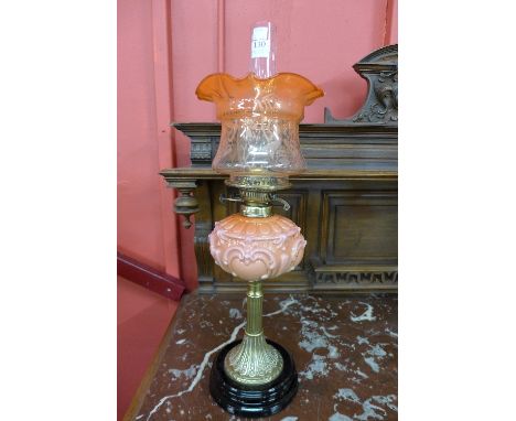 A Victorian brass and pink glass oil lamp