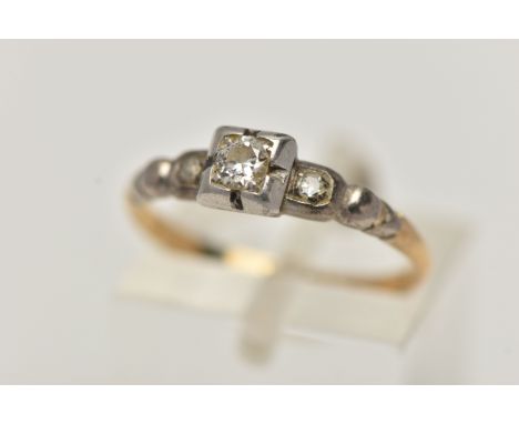 A THREE STONE DIAMOND RING, set with a round brilliant cut diamond and two single cuts in a white metal mount leading on to a